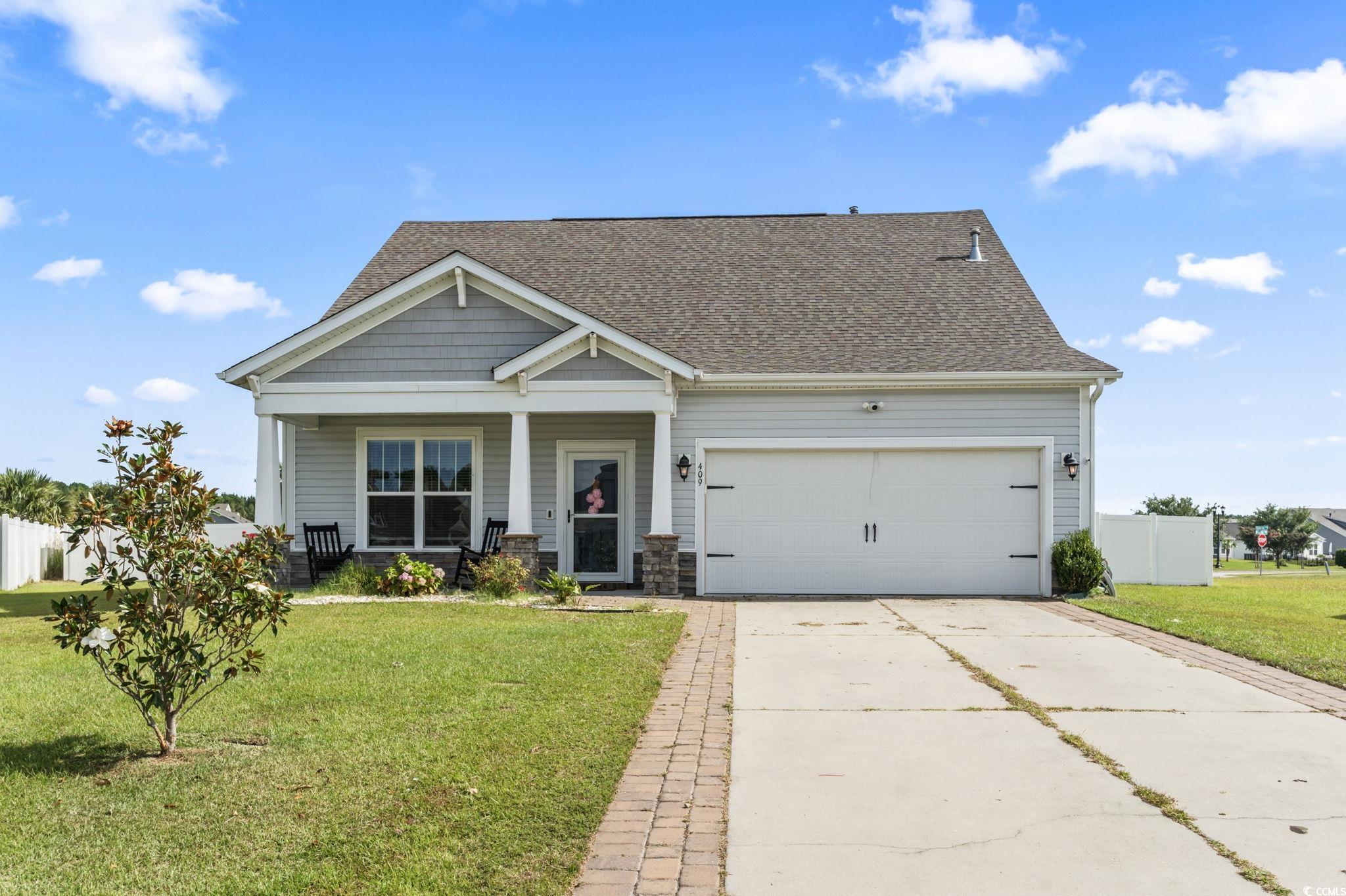 Craftsman house with a garage, a porch, and a fron