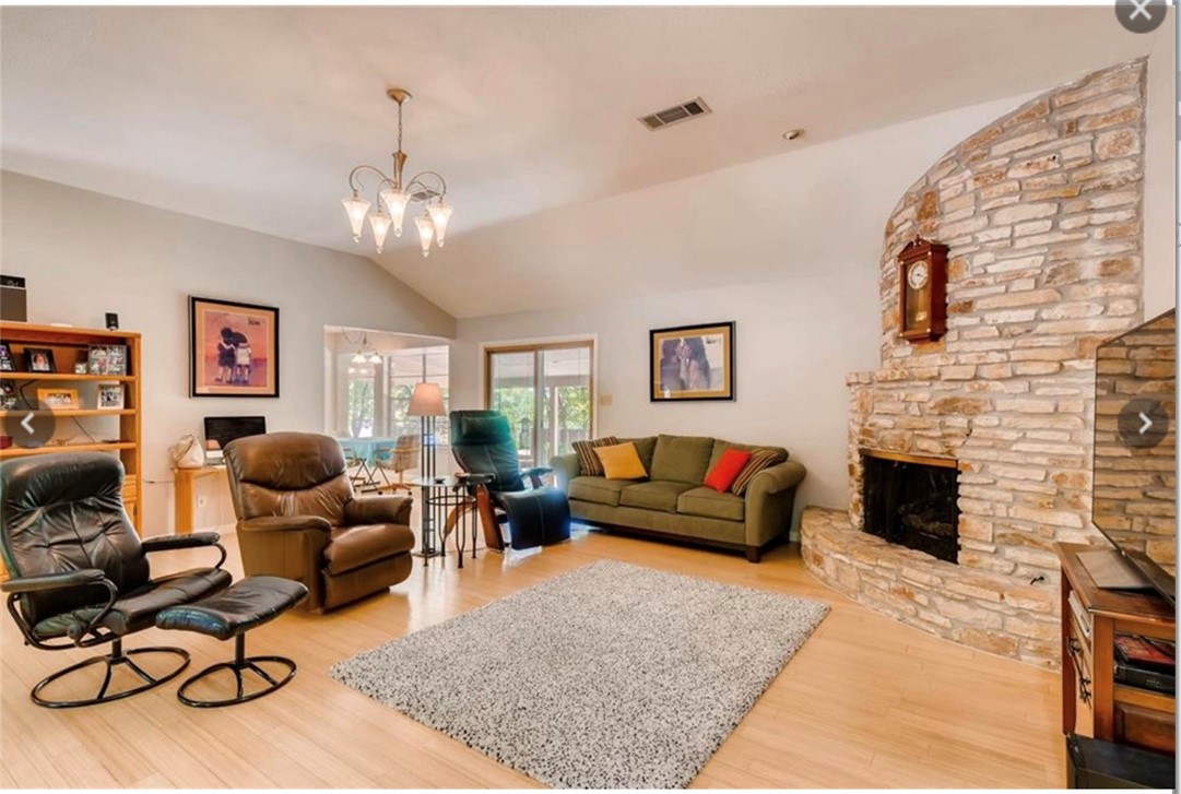 a living room with furniture a rug and a fireplace