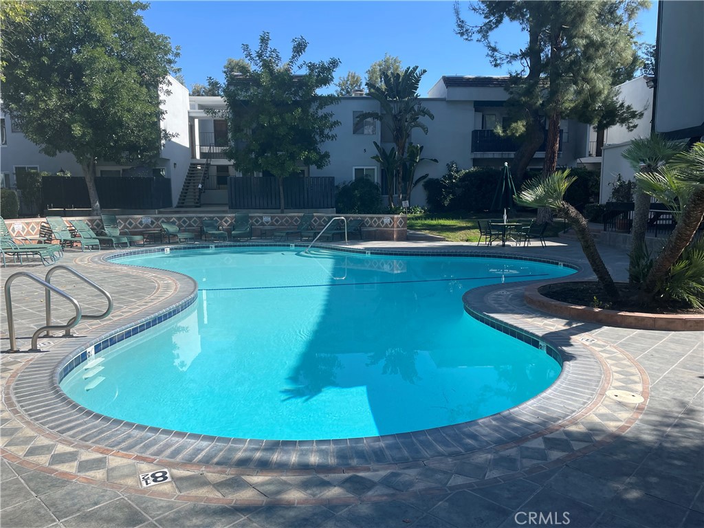 a view of a swimming pool with sitting area