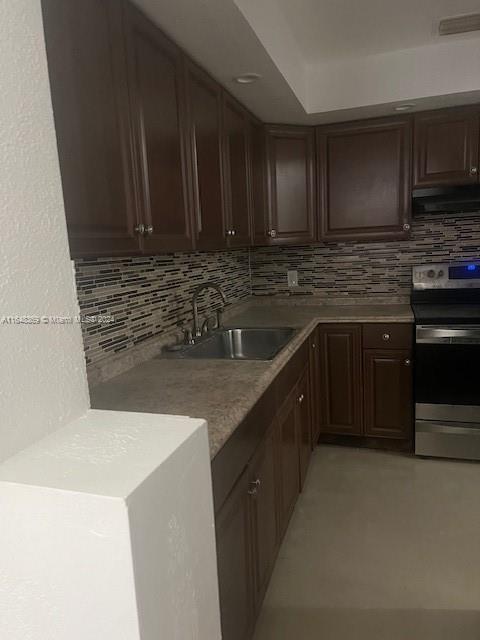 a kitchen with stainless steel appliances wooden cabinets and a sink