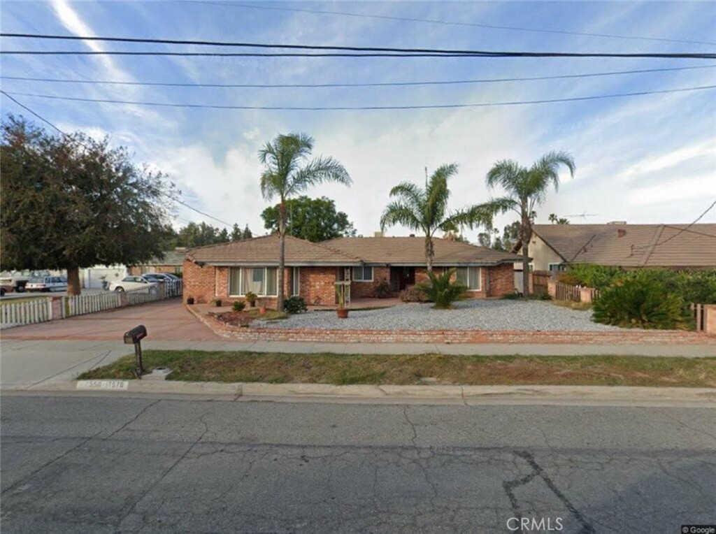 a view of a house with a swimming pool and a yard