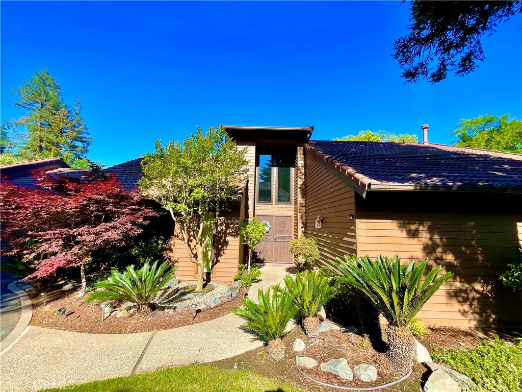 a house with flower garden in front of it