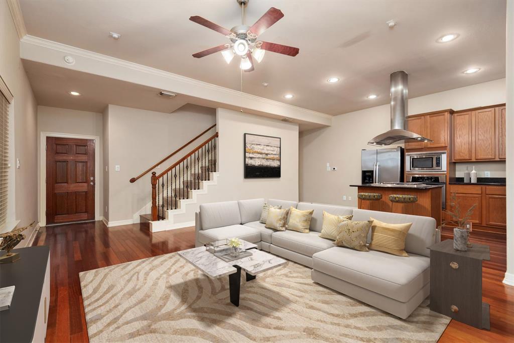 a living room with furniture and kitchen view