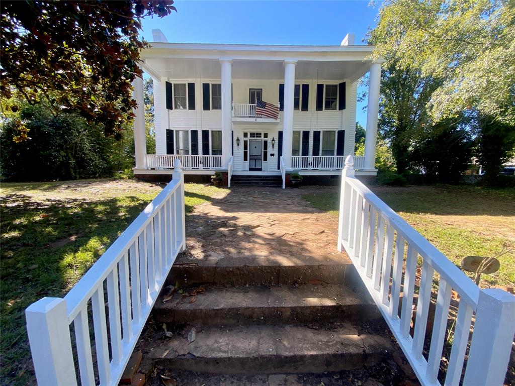 a view of an house with swimming pool from a balcony