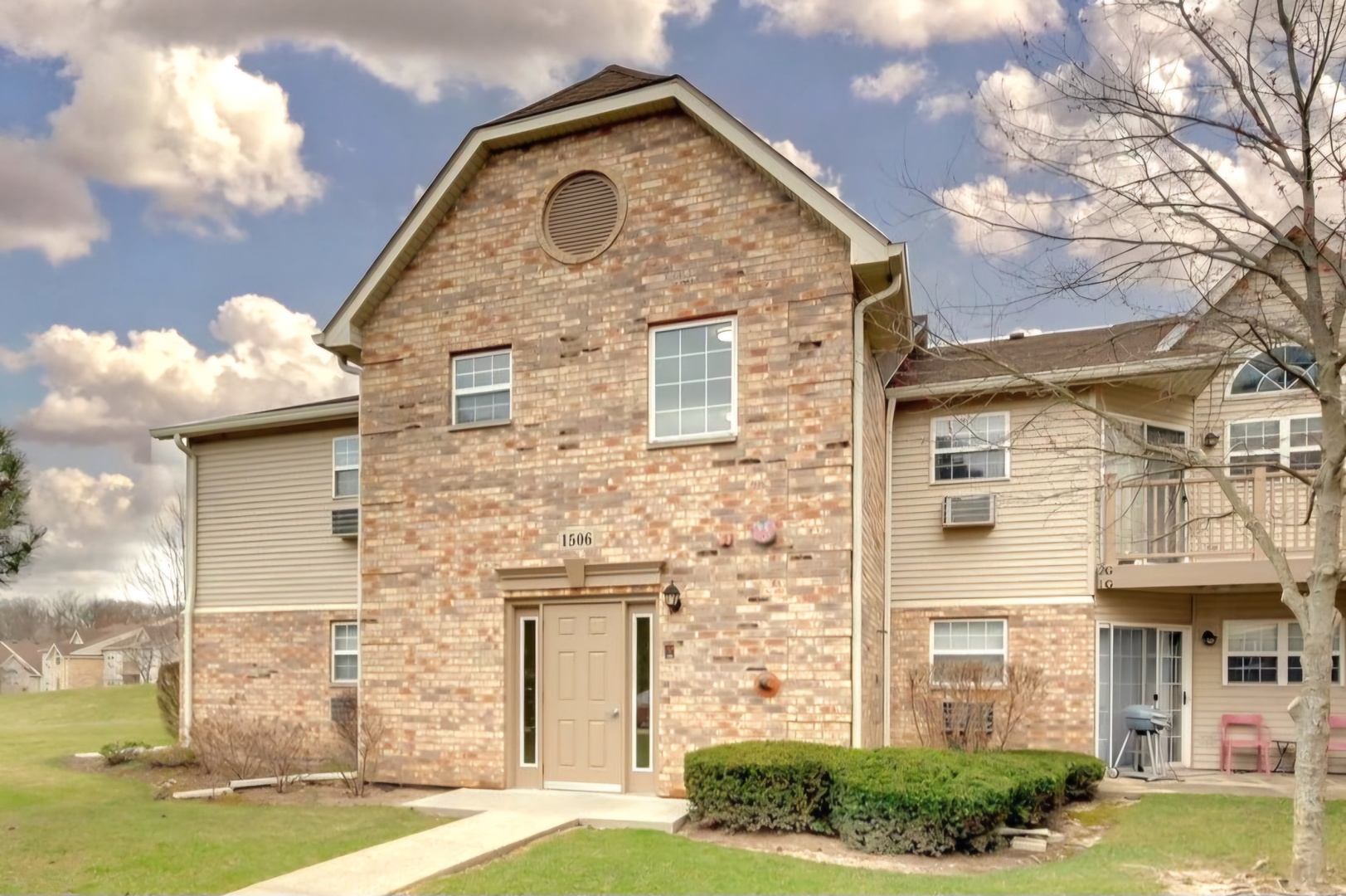 a view of a brick house with a yard