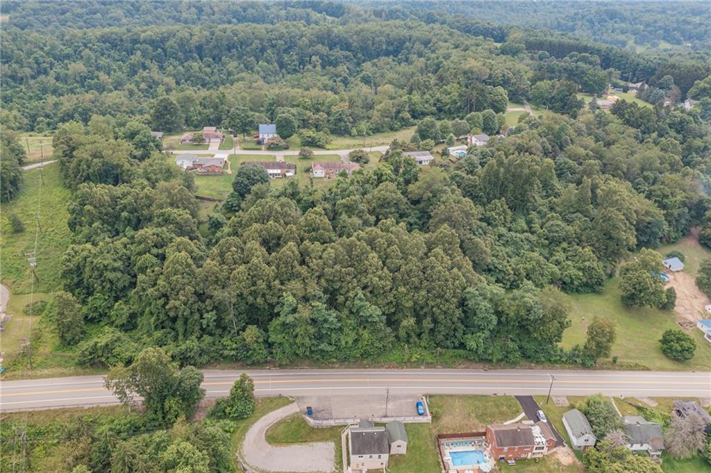 an aerial view of a house with yard