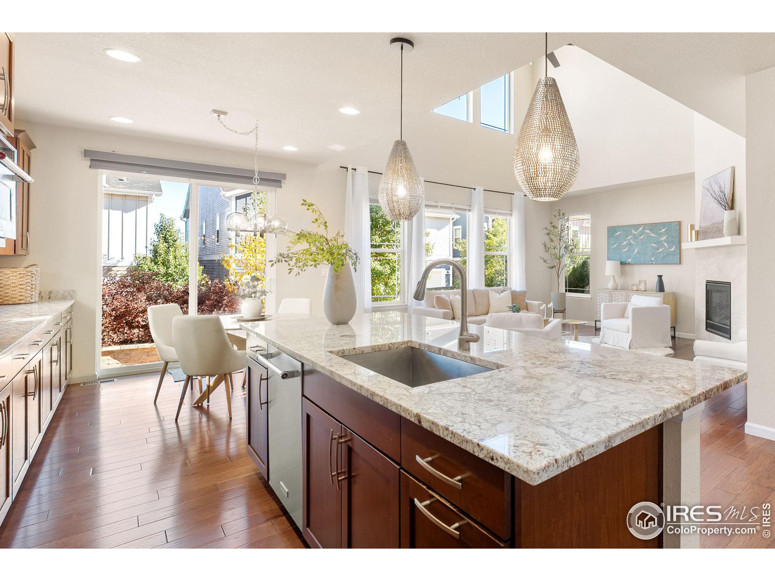 a kitchen with a table chairs and wooden floor