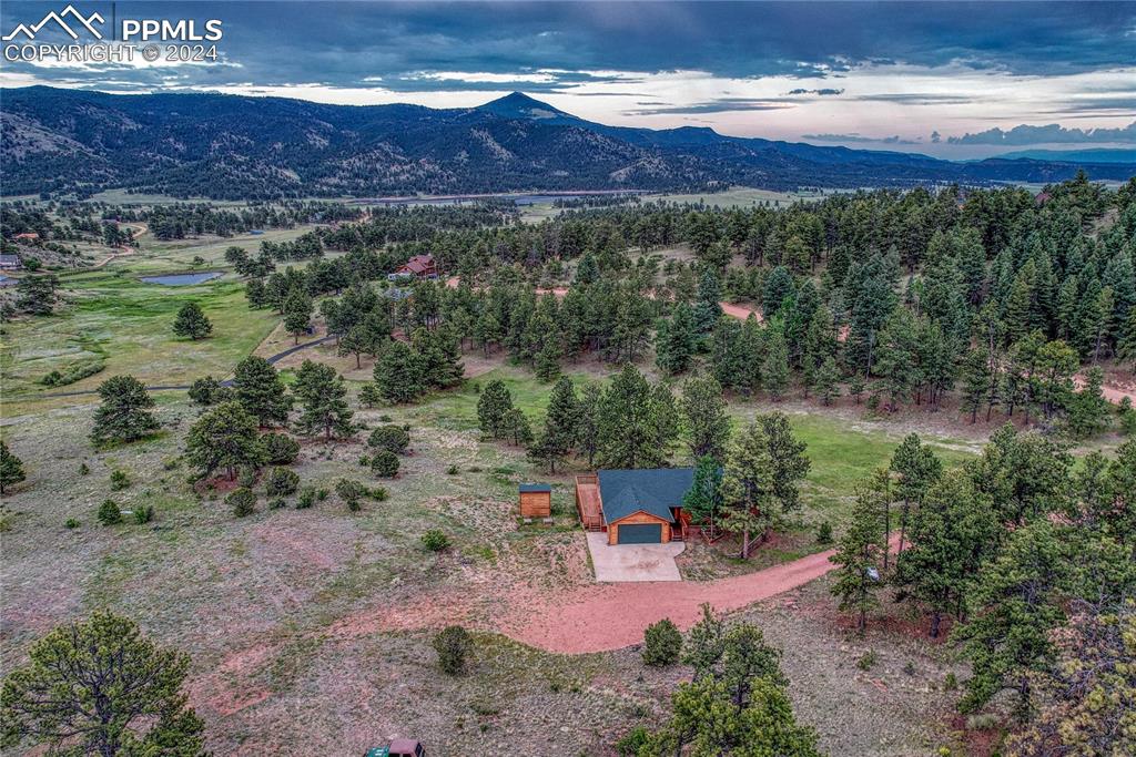 an aerial view of a house with a yard