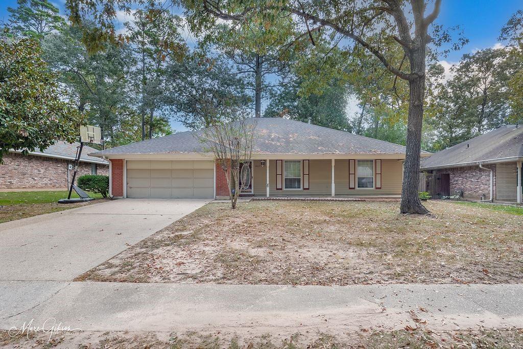 a front view of a house with a yard and a garage