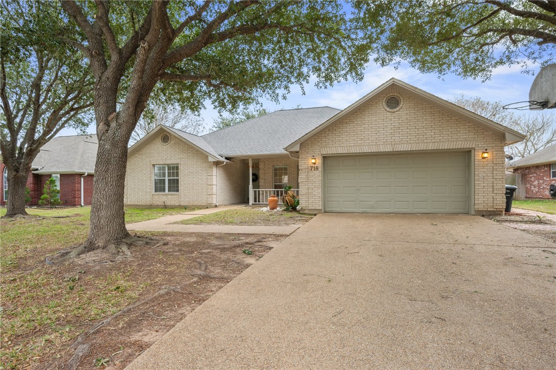 Great front elevation shaded by mature trees