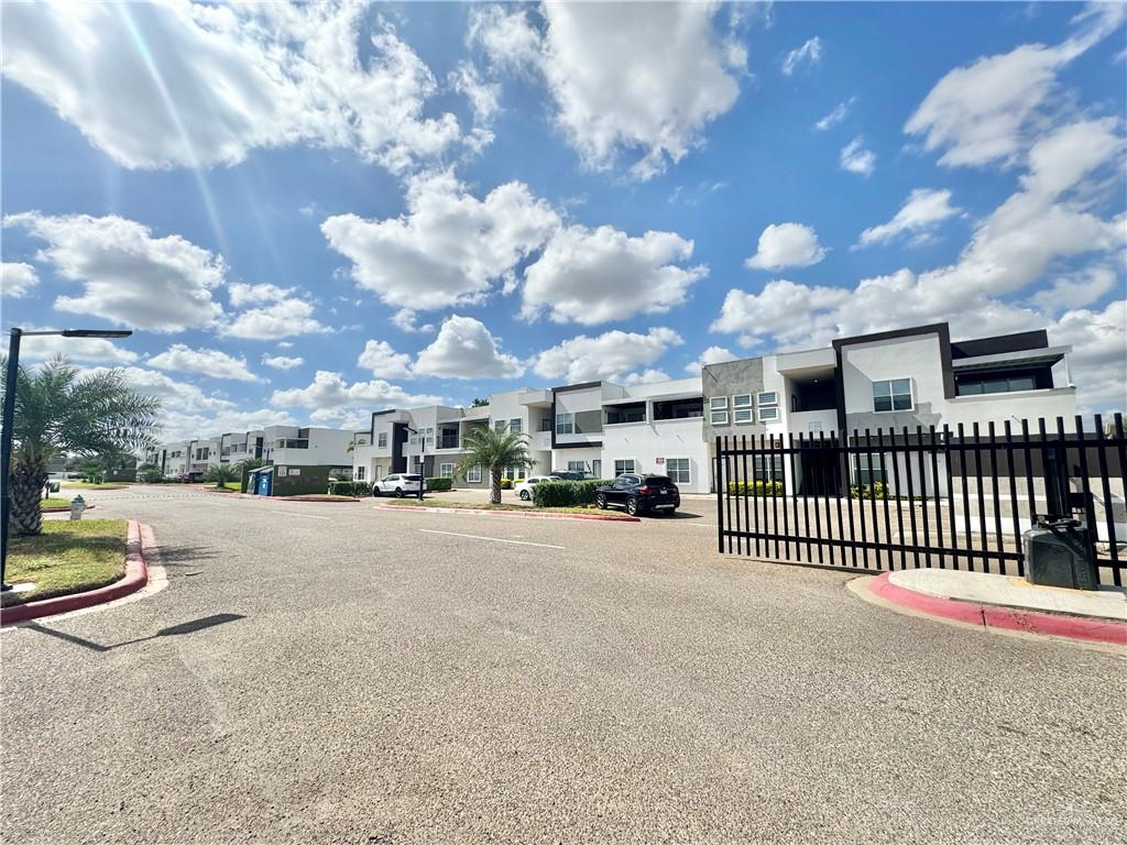 a view of a street with a cars park side of a road