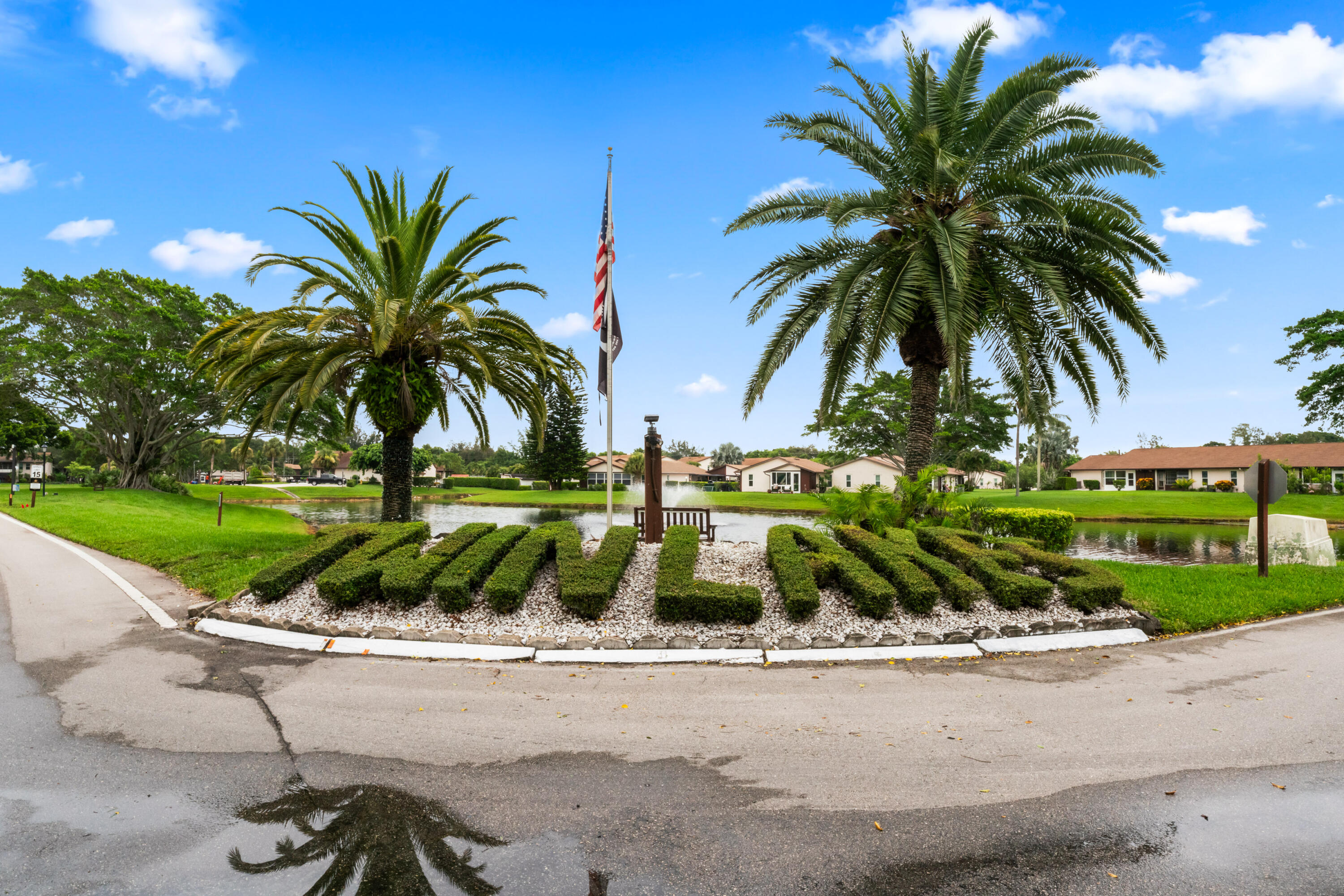 front view of house with a palm tree