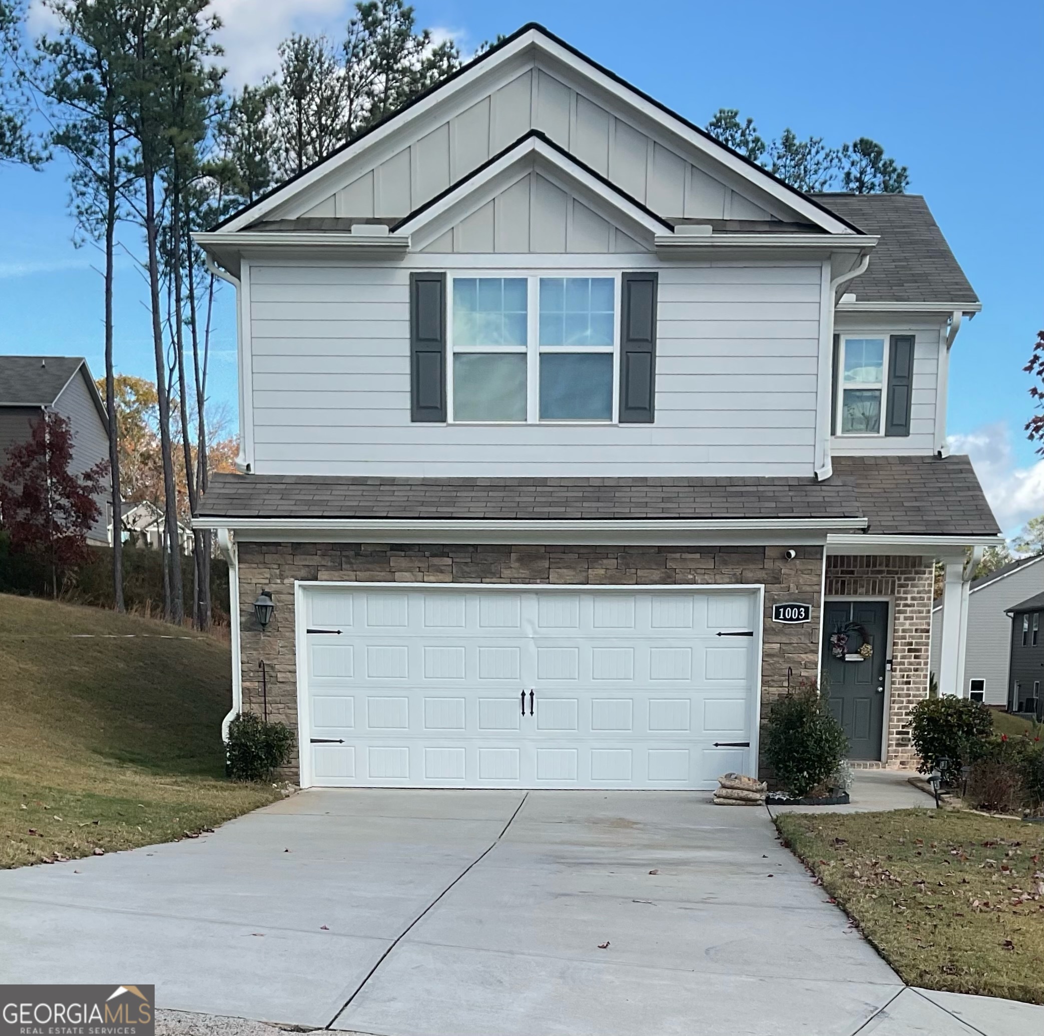 a front view of a house with garage