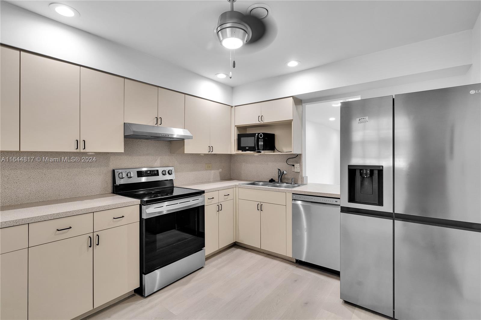 a kitchen with stainless steel appliances and white cabinets