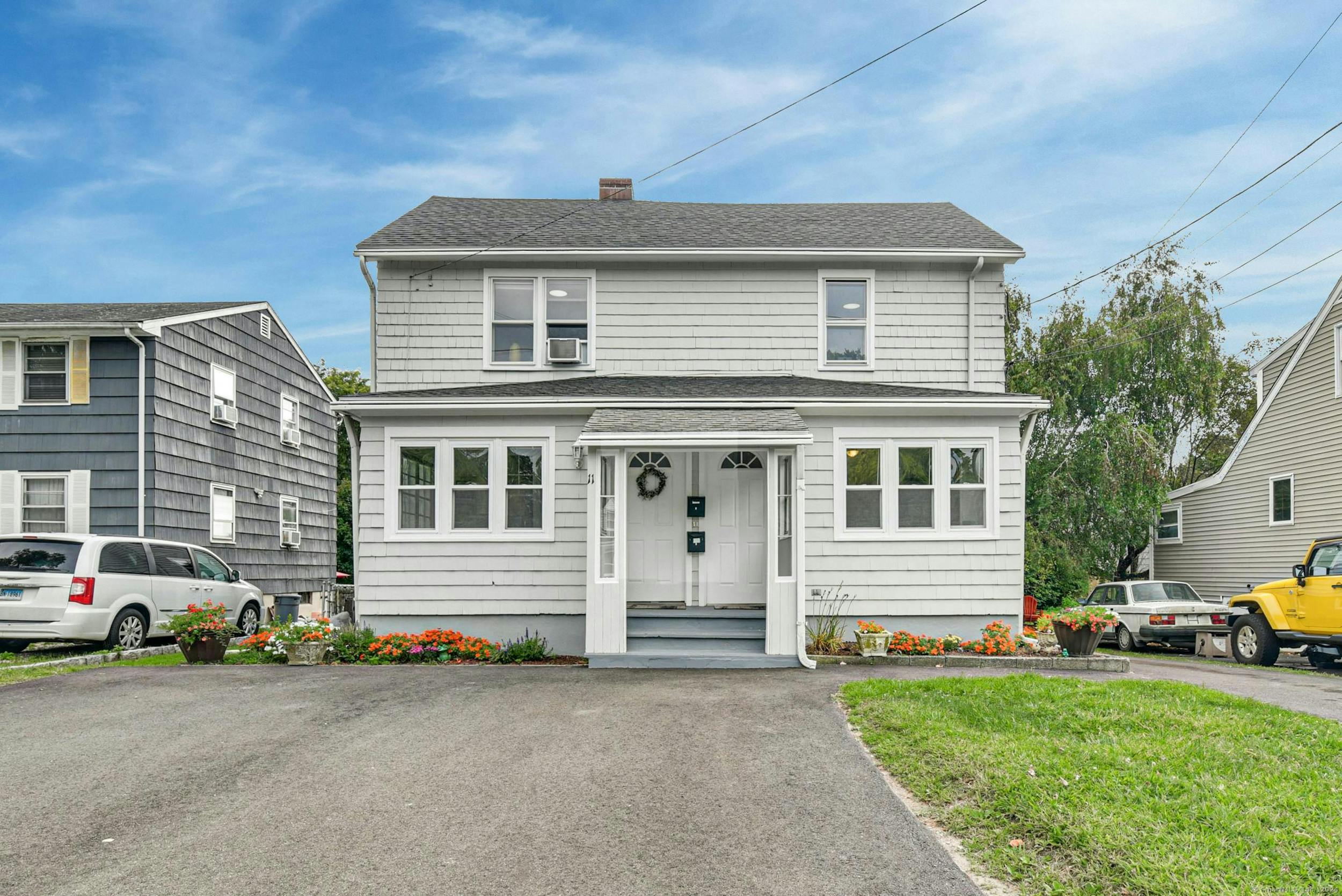 a front view of a house with a garden