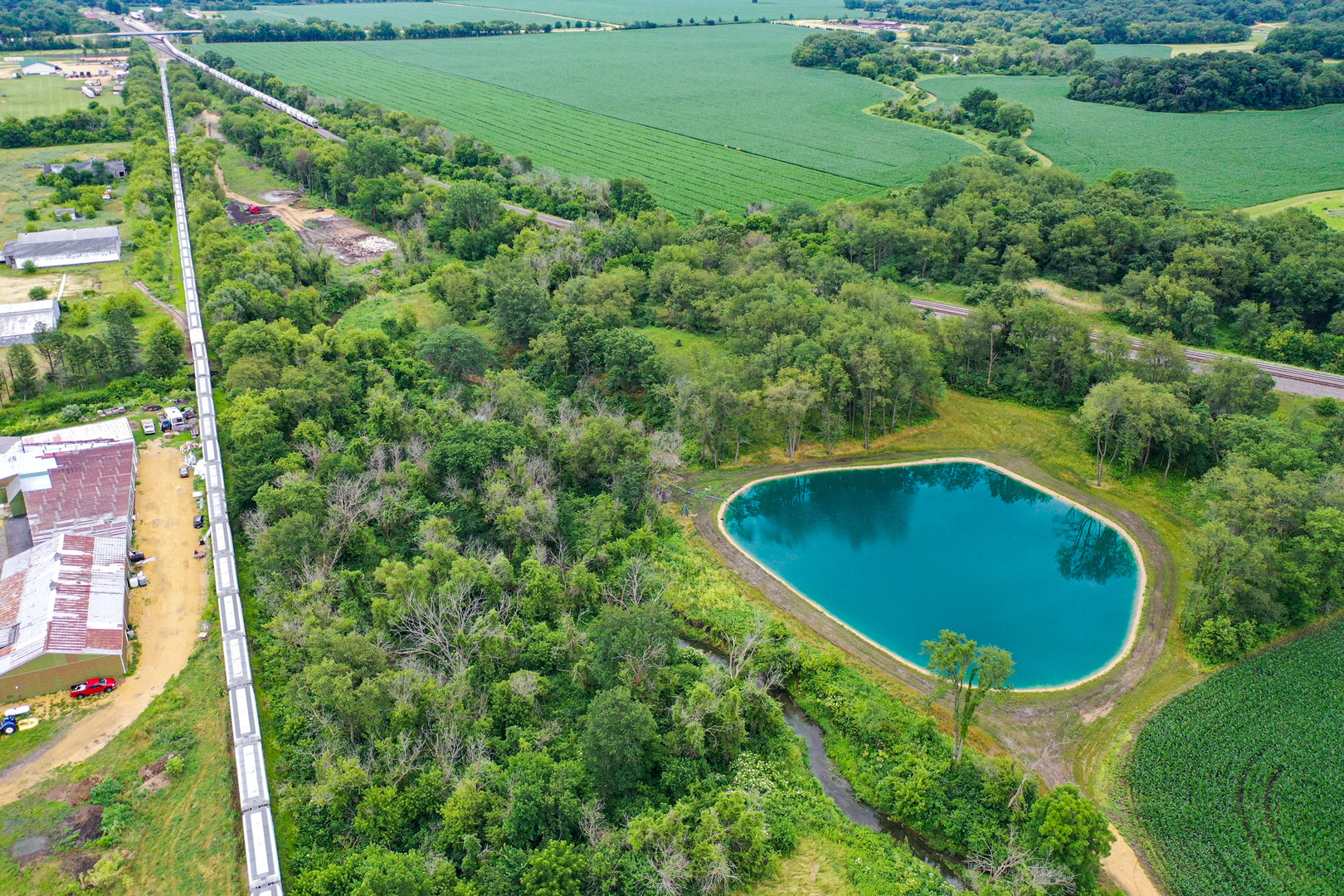 an aerial view of a house with pool garden and yard