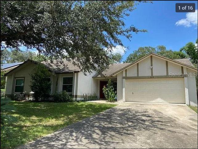 a view of a house with yard and tree s