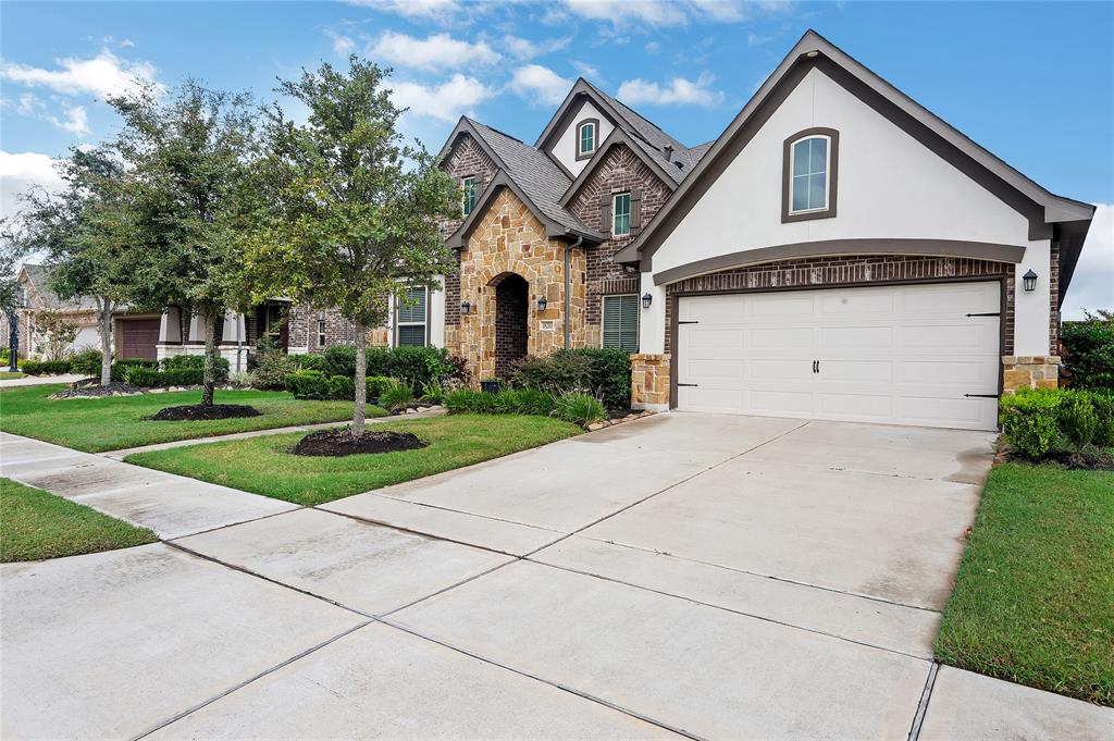 Welcome home to your spectacular quality Newmark built home in much sought after Towne Lake.  No cookie cutter home here with its soaring ceilings , enormous wide open kitchen, dining, and living room spaces, and just look at this multi material and peaks elevation!