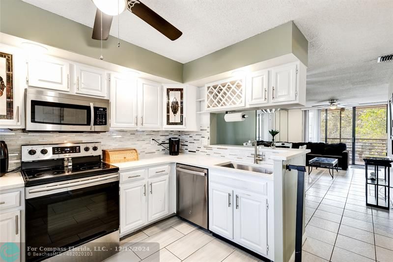 a kitchen with a sink stove and microwave