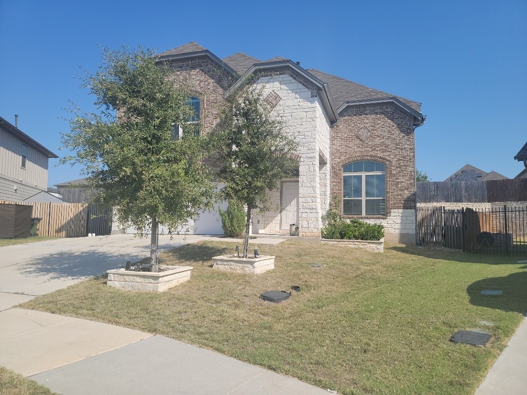 a view of a house with a yard and garage