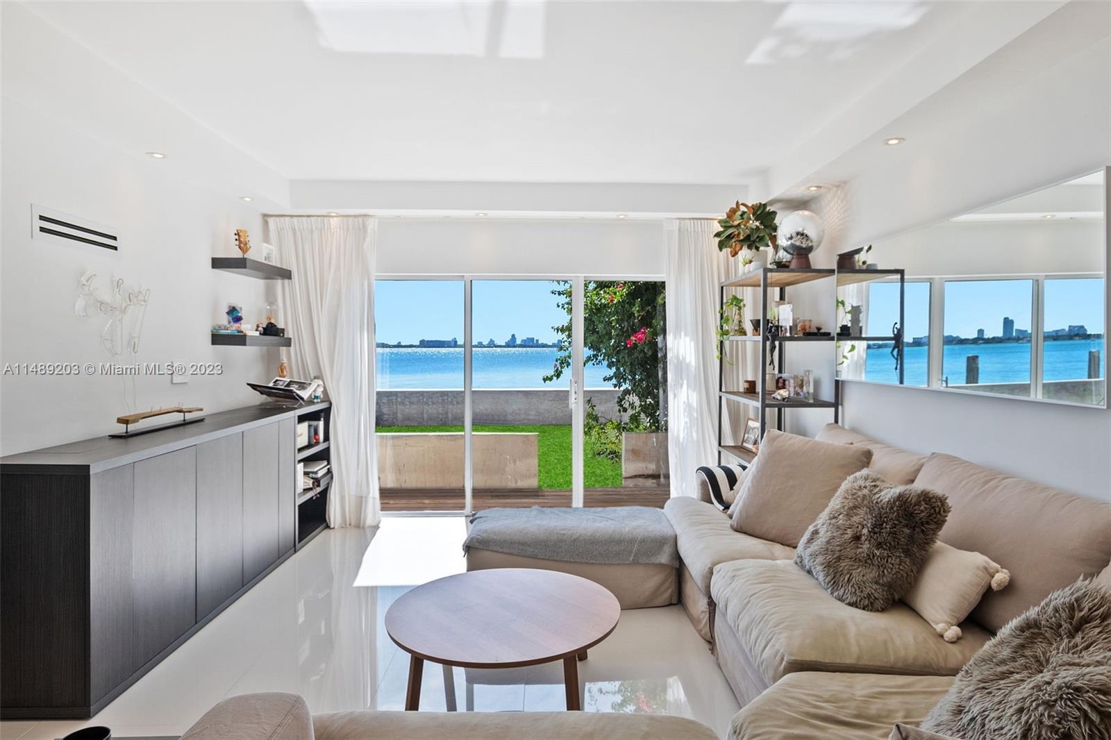 a living room with furniture and a kitchen