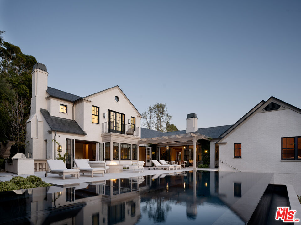 a aerial view of a house with swimming pool and sitting area