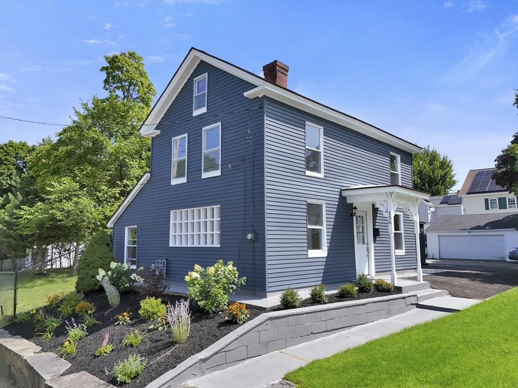 a front view of a house with garden