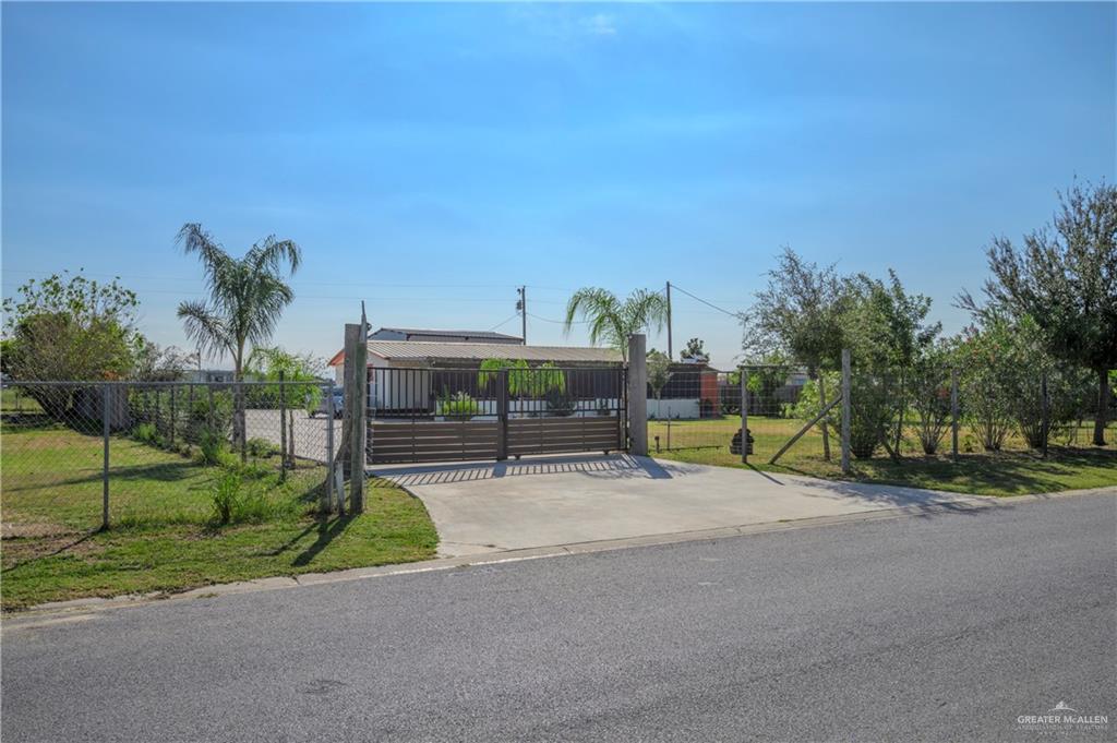 a view of backyard with swimming pool and seating space