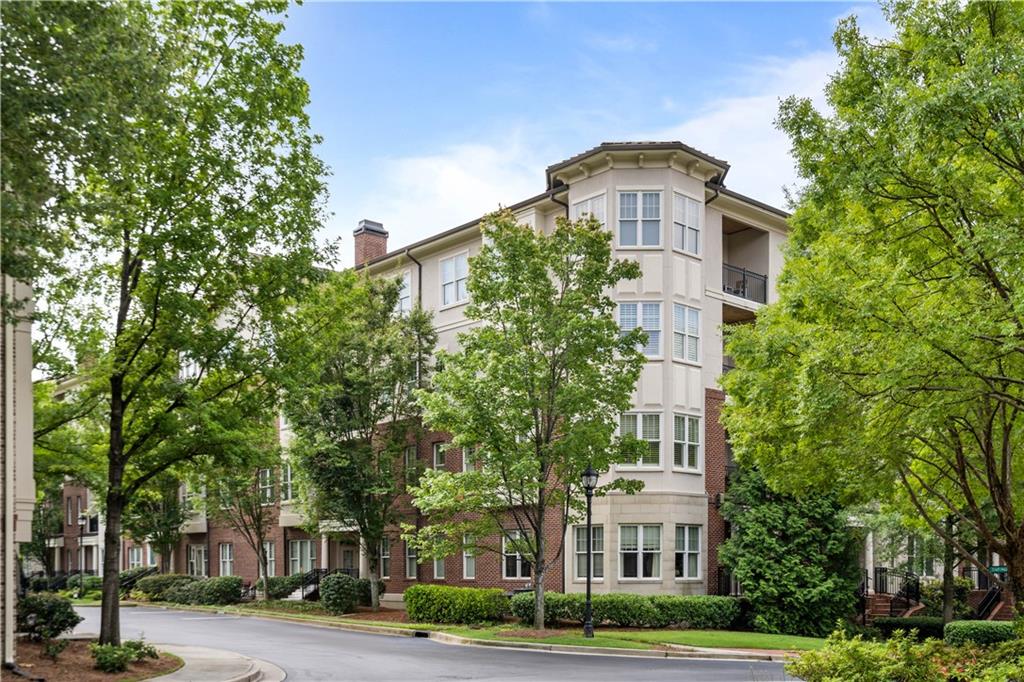 a front view of a residential apartment building with a yard