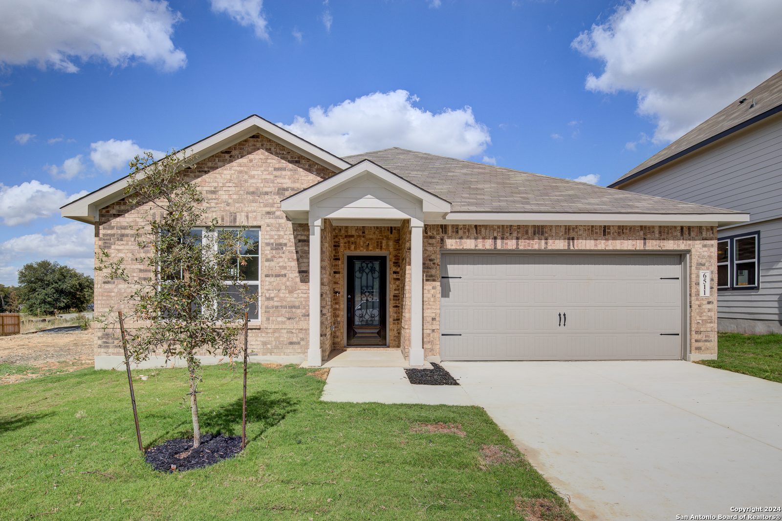 a front view of a house with a yard and garage