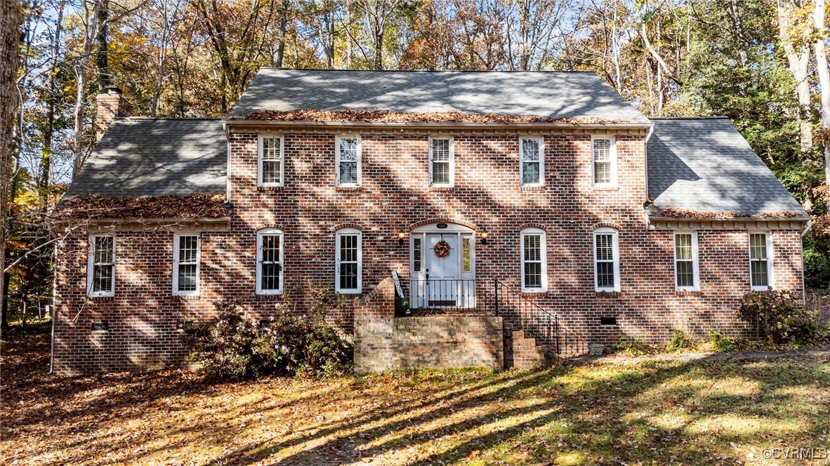 Colonial inspired home with a front lawn