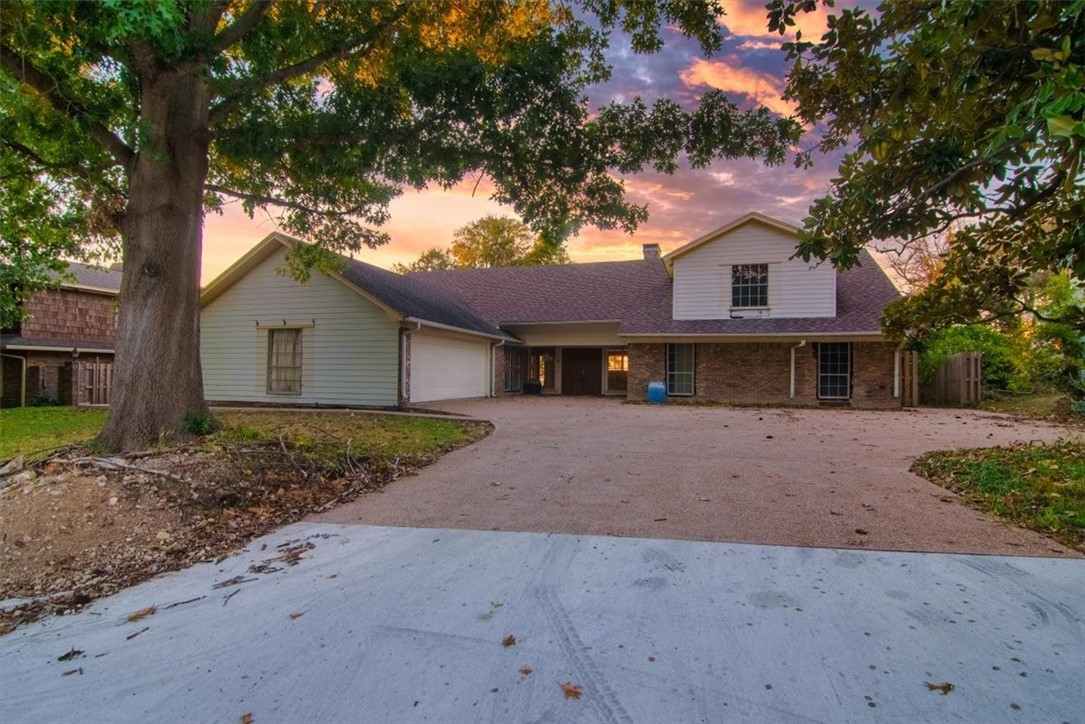 a front view of a house with a yard and a garage