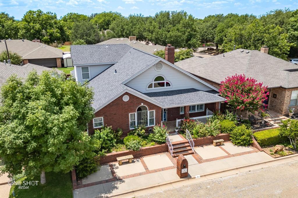 a aerial view of a house with a yard and a garden