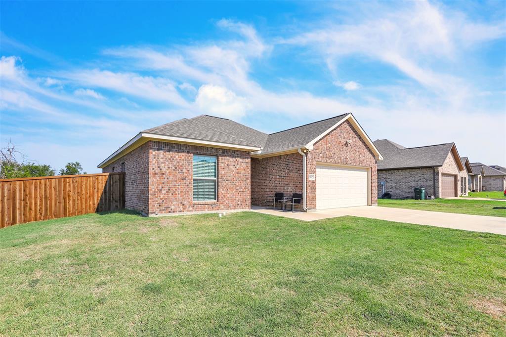 a view of a house with a yard and garage