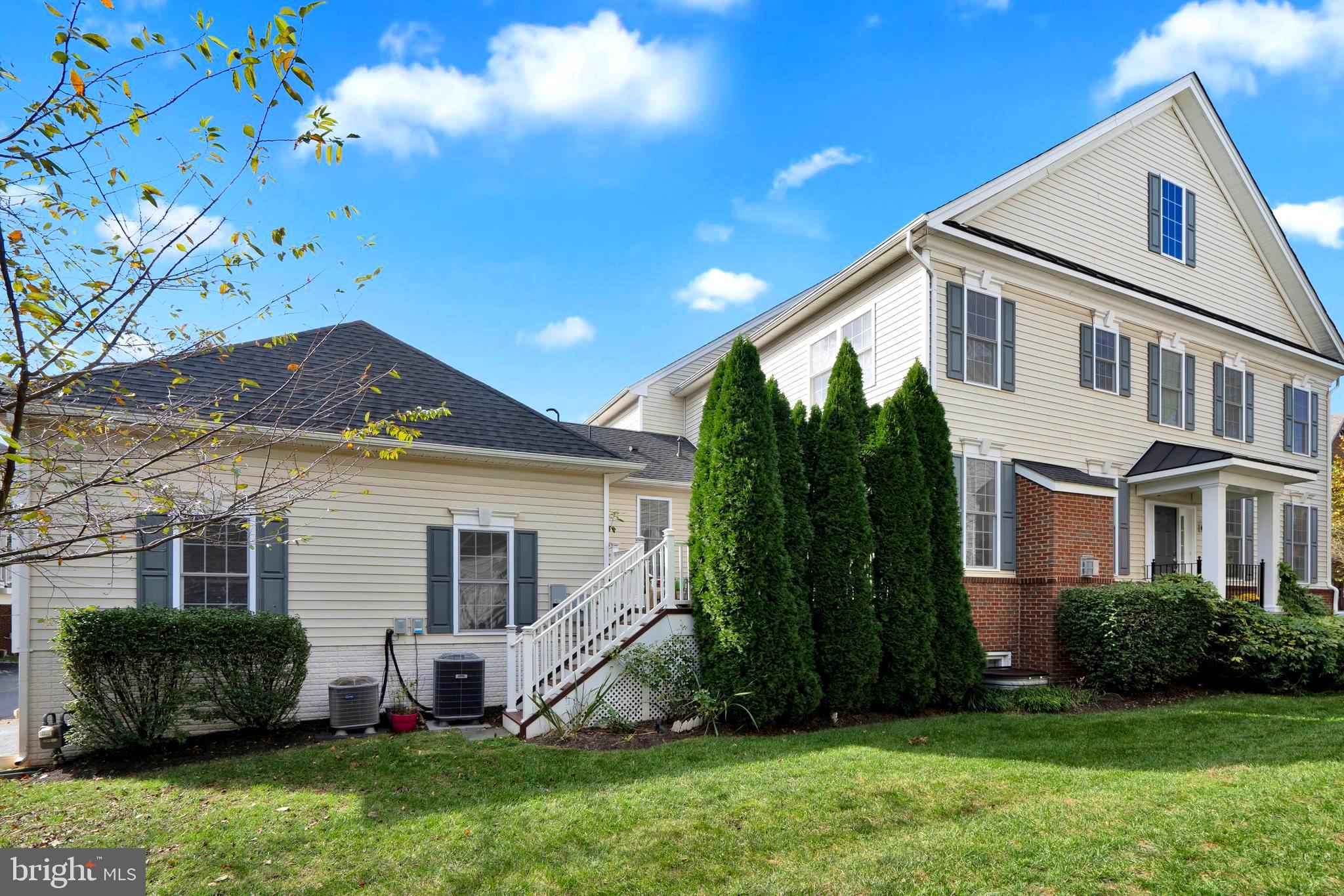 a front view of a house with a garden and plants