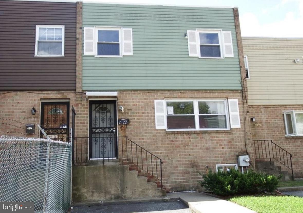 a view of a house with brick walls