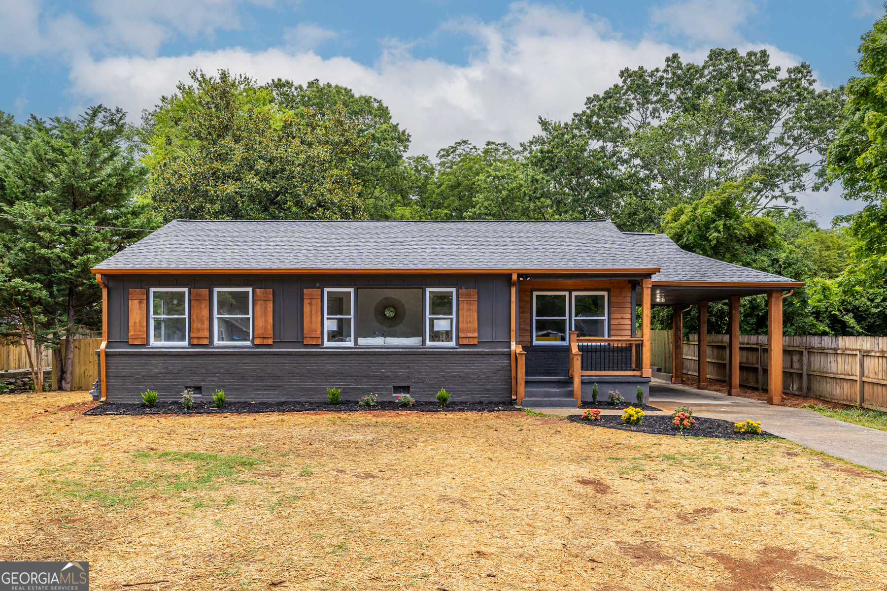 a front view of a house with a yard covered with green space