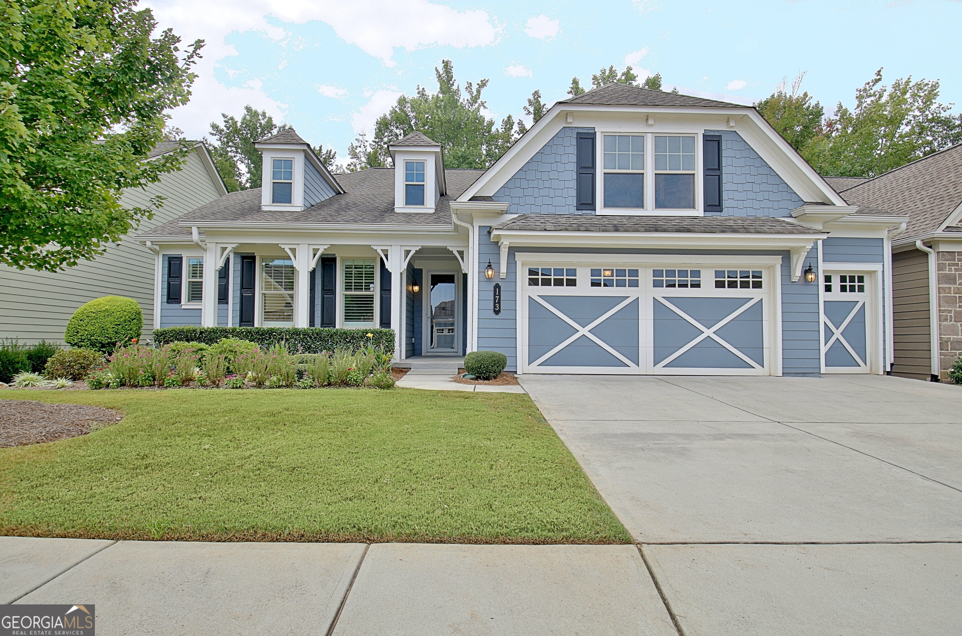 a front view of a house with a yard and garage