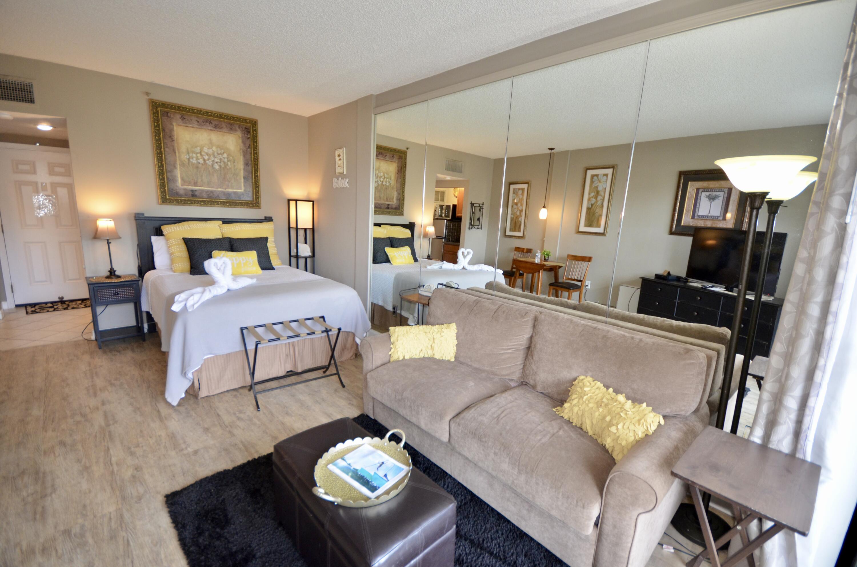 a living room with furniture and a lamp