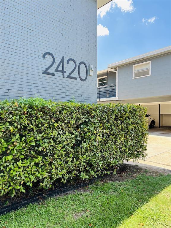 a view of a brick house with a yard