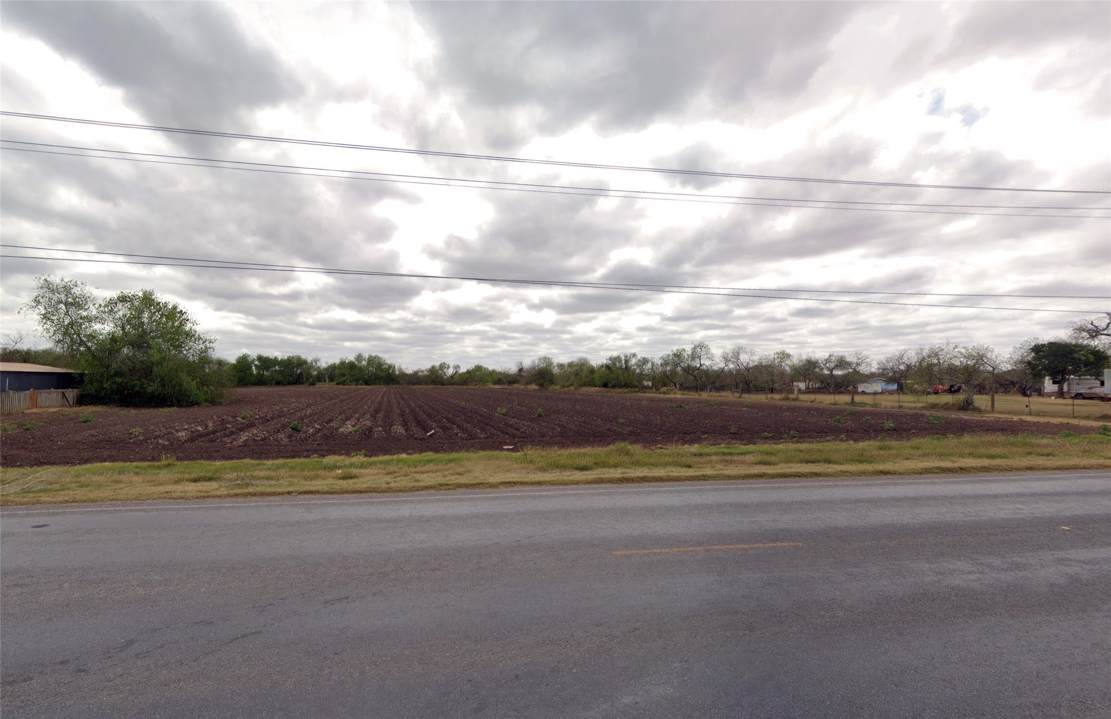 a view of a big yard and mountain view in back