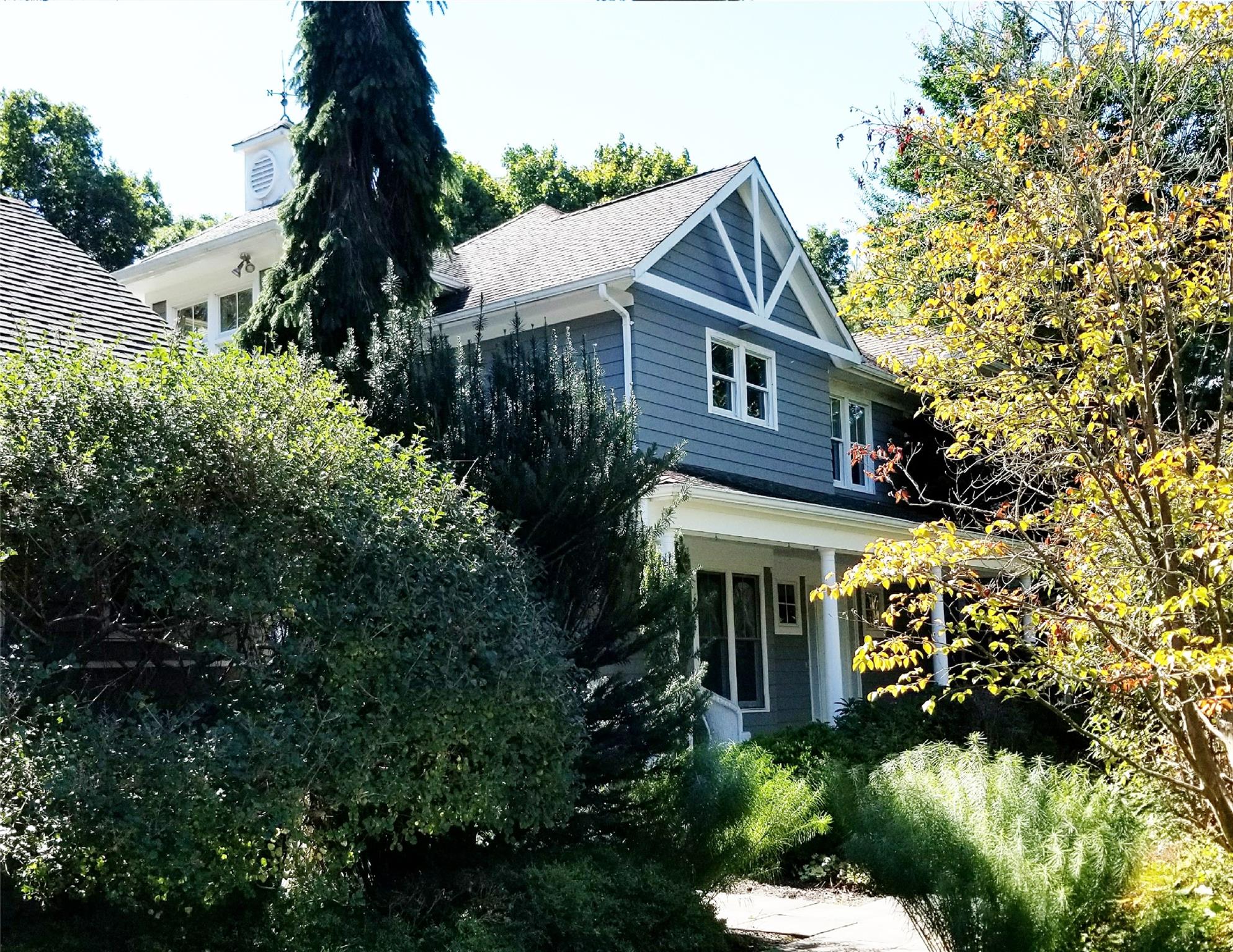 a front view of a house with a garden