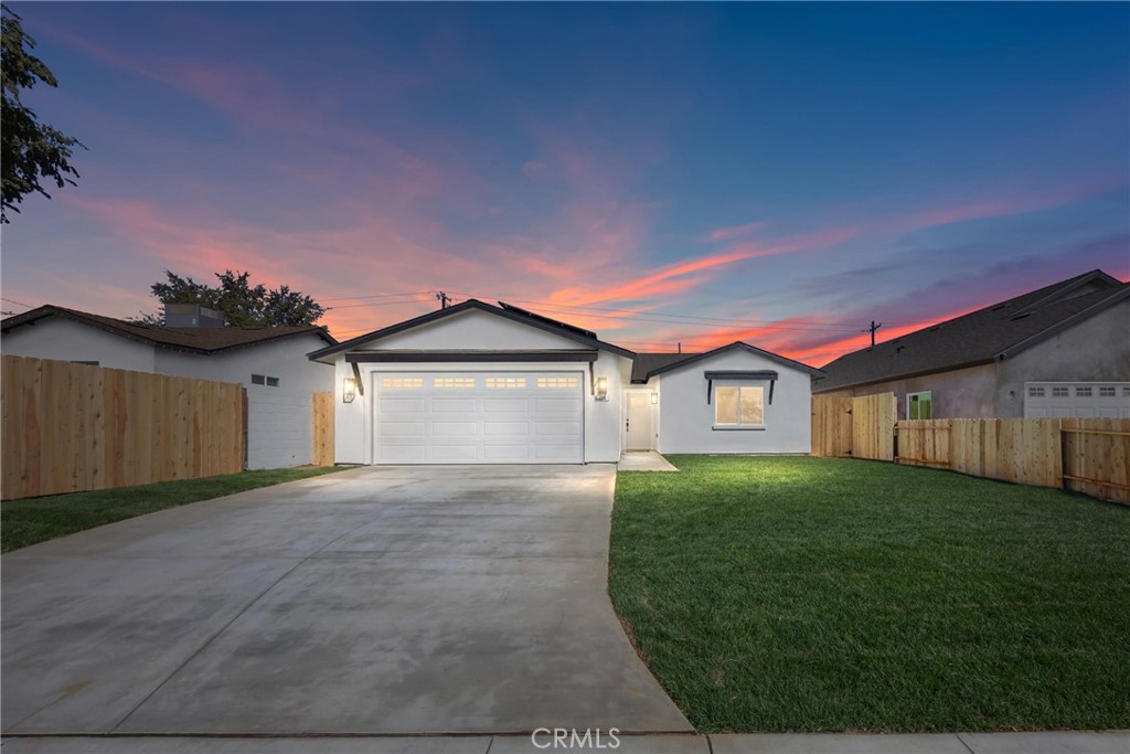 a view of a house with a yard and garage