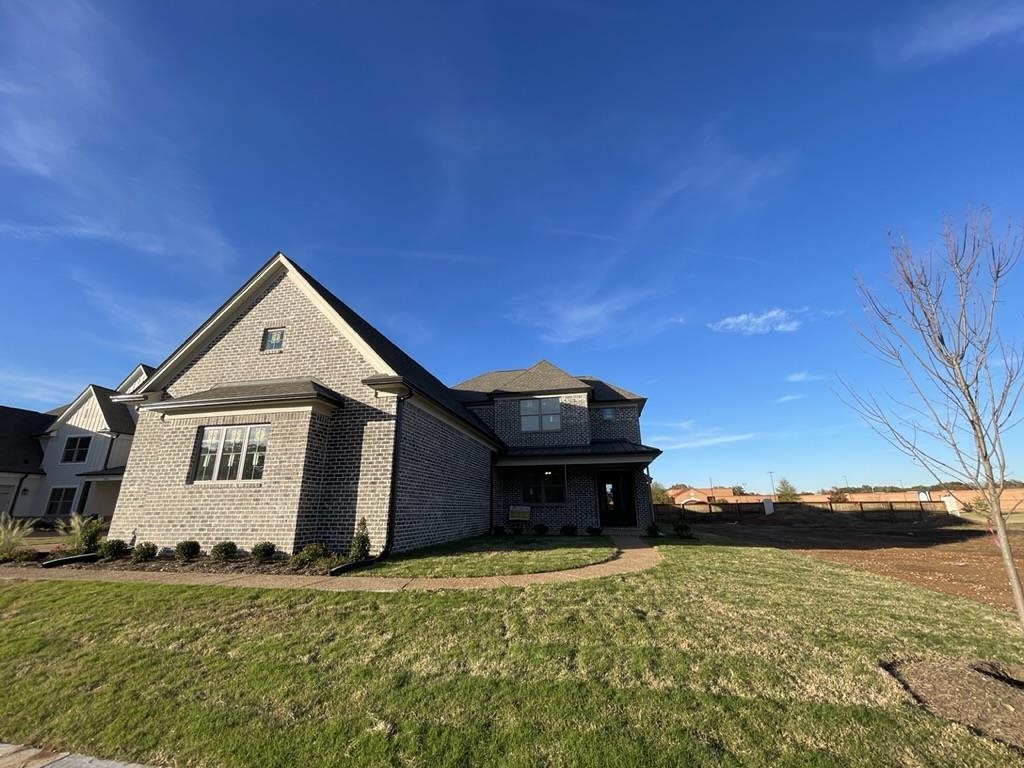 a front view of a house with a yard