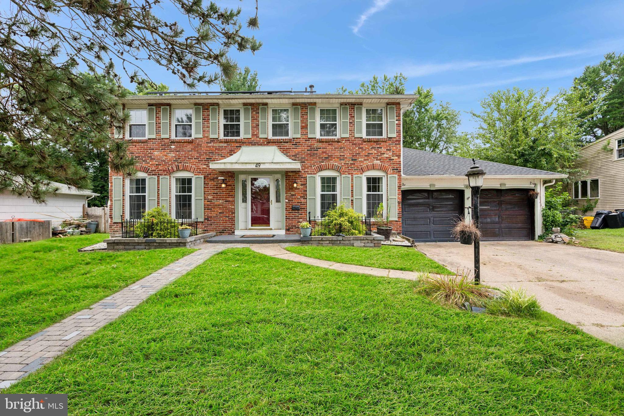 a front view of a house with a yard and porch