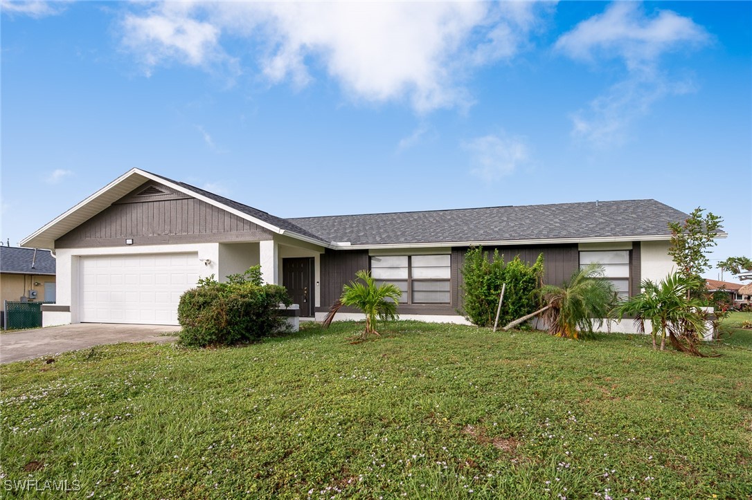 a front view of house with yard and green space