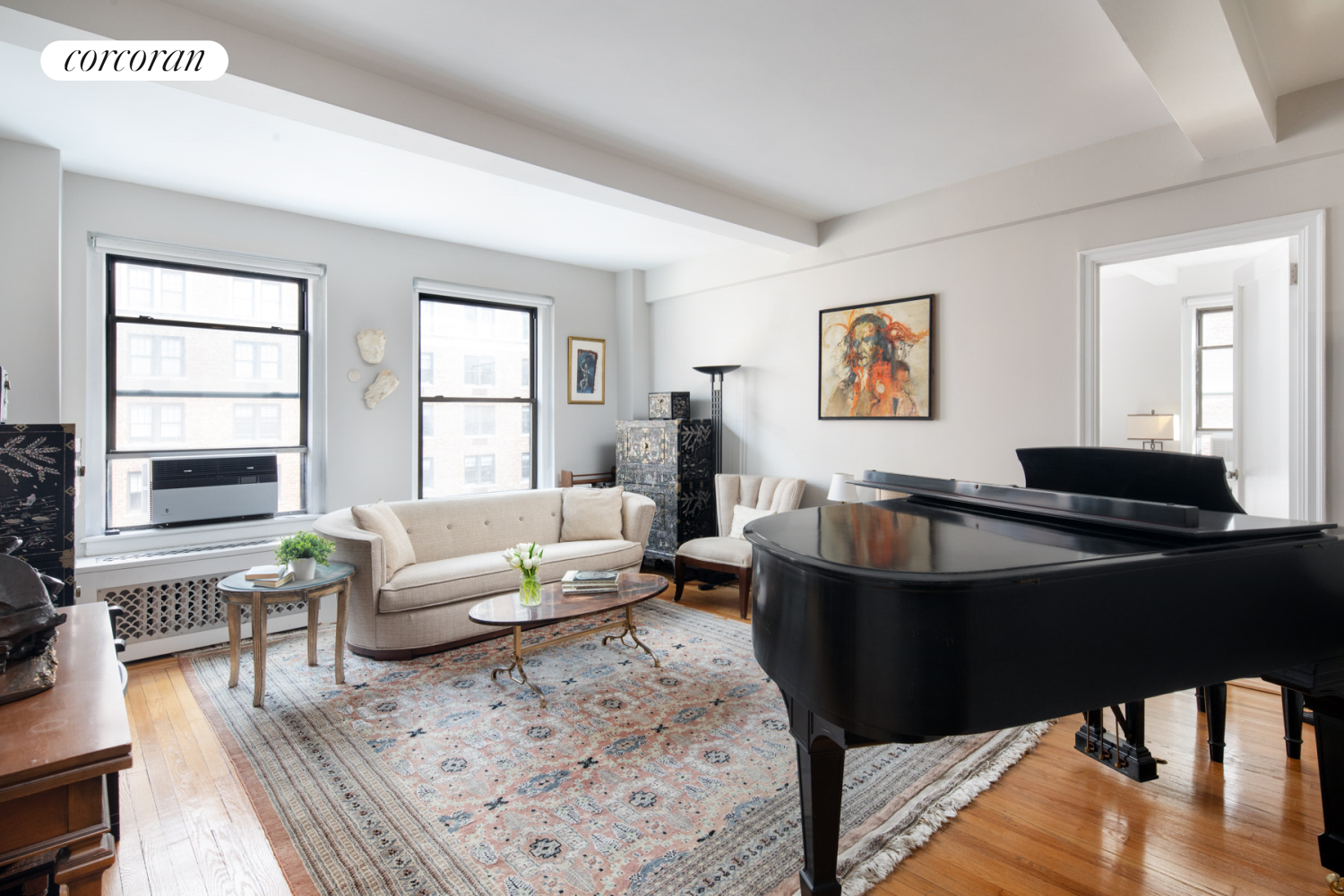 a living room with furniture and wooden floor