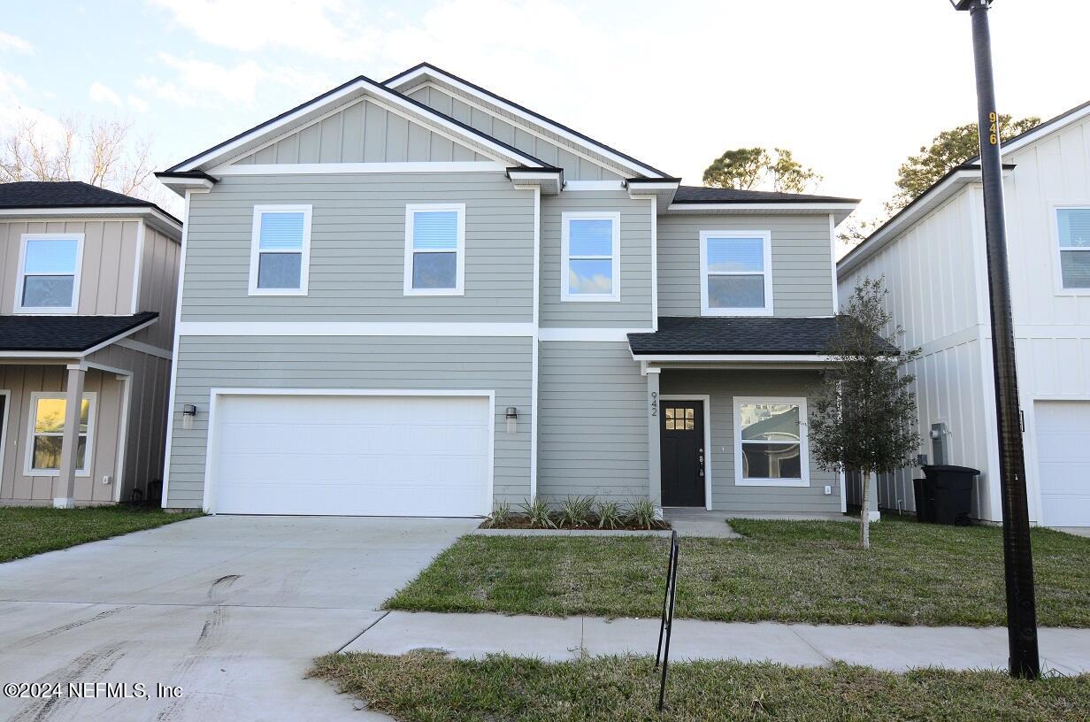 a front view of a house with a yard and garage