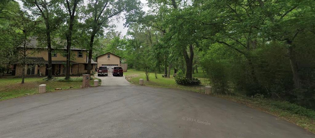 a view of a house with a backyard and tree