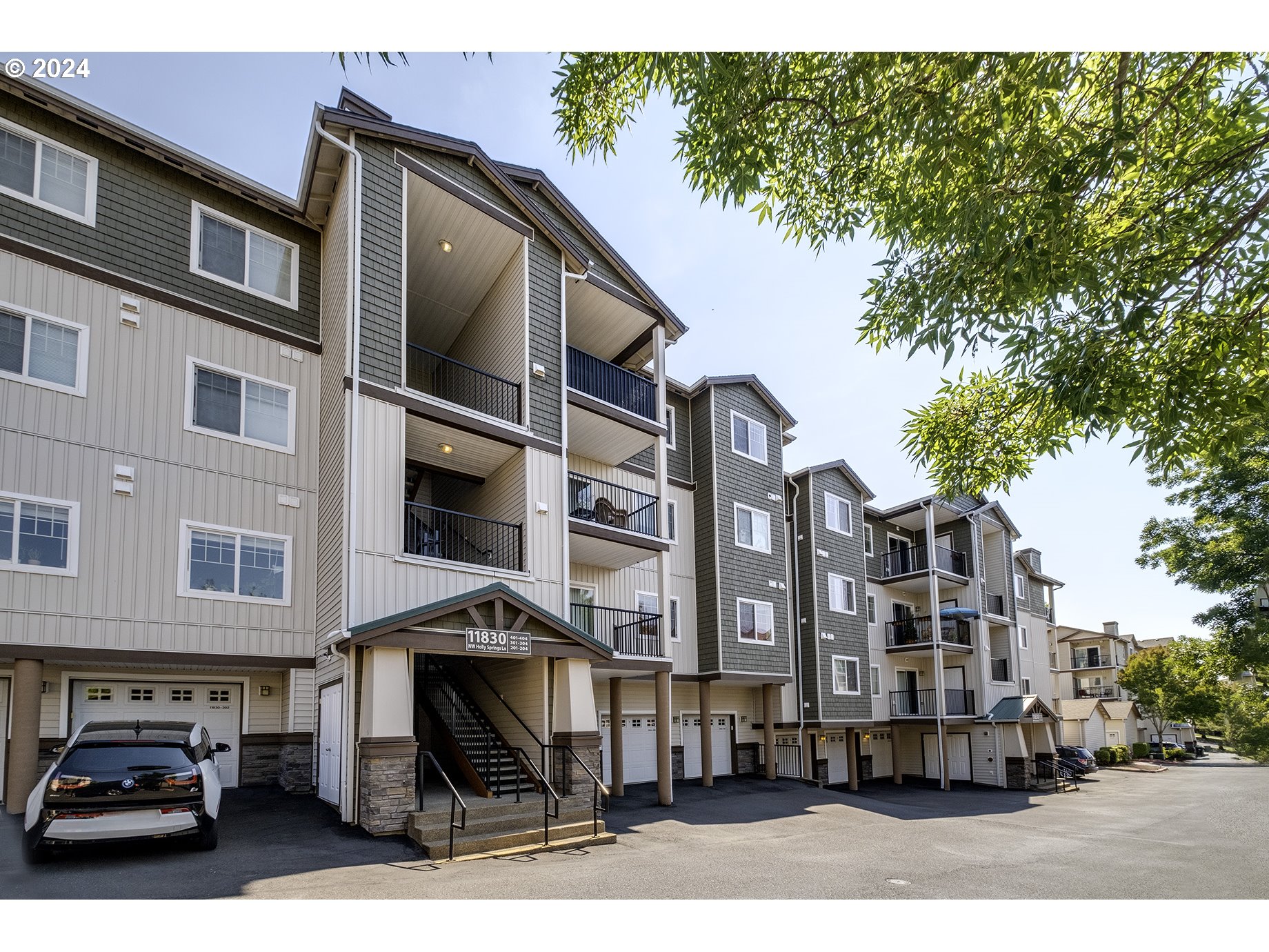 a front view of a residential apartment building with a yard